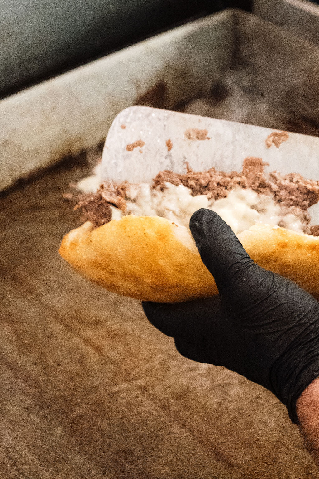 holding a homemade cheesesteak from Joe's East End