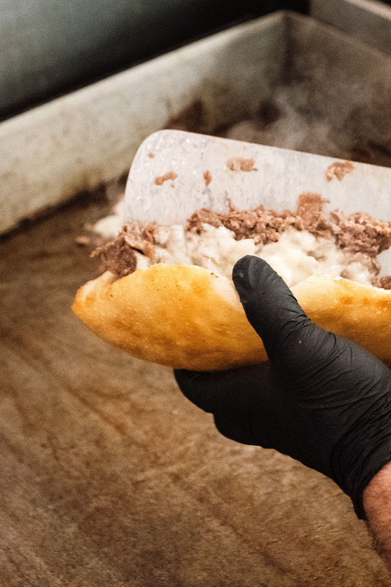 holding a homemade cheesesteak from Joe's East End